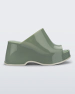 Side view of a green Patty platform mule with beige sole