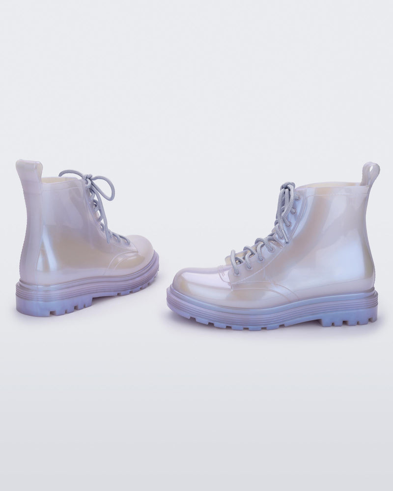 Angled view of a pair of pearly blue kids Melissa Coturno boots.