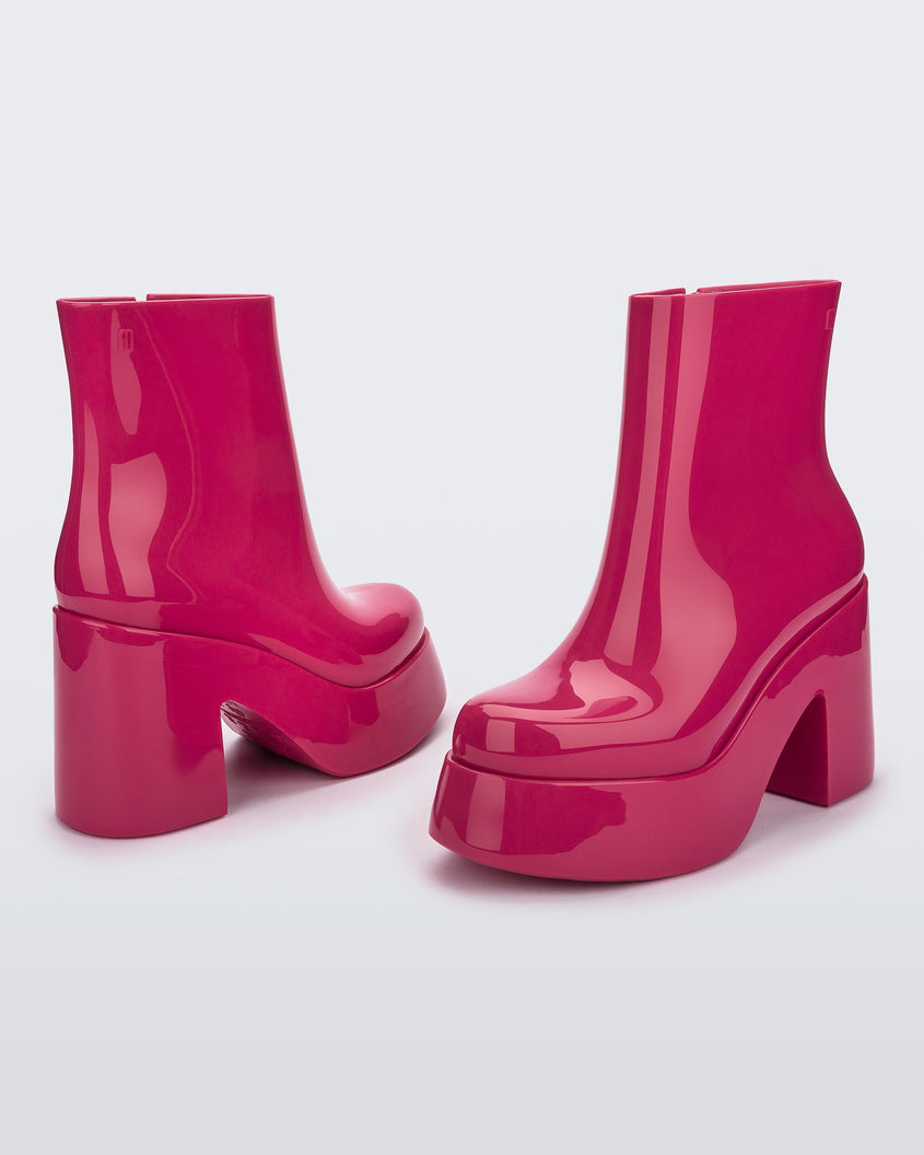 Angled and back view of a pair of pink Melissa Nubia platform heel boots.