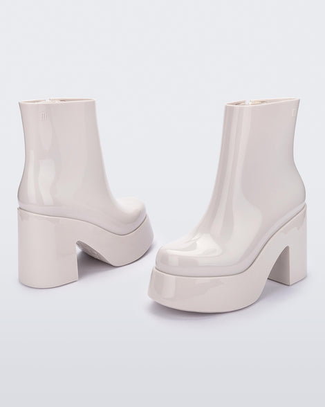 Angled and back view of a pair of white Melissa Nubia platform heel boots.