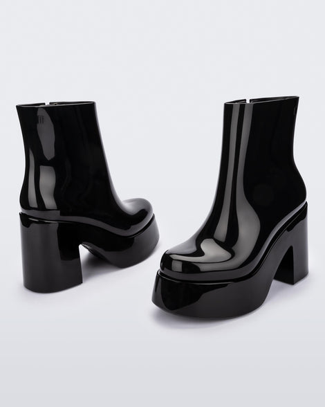 Angled and back view of a pair of black Melissa Nubia platform heel boots.