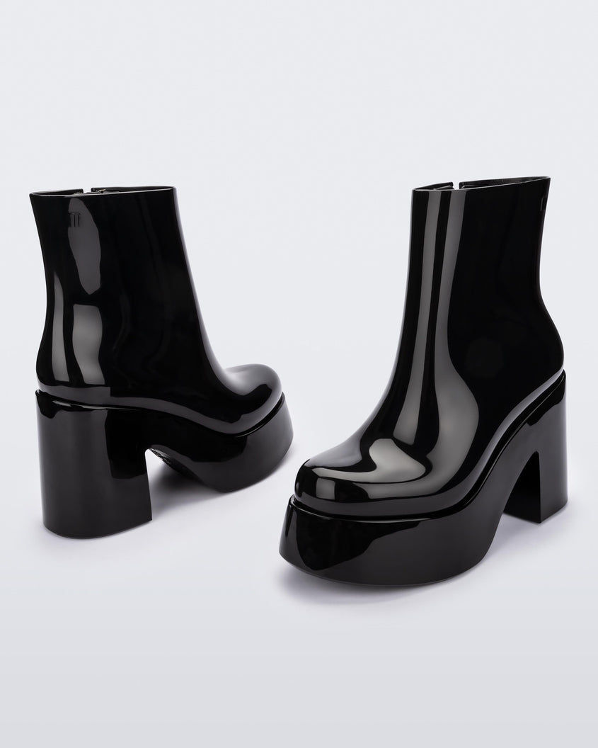 Angled and back view of a pair of black Melissa Nubia platform heel boots.