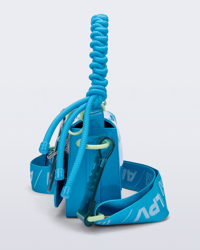 Side view of an blue Olga Bag + Alexandre Pavao with short strap fabric long strap