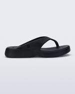 Side view of a black Free Thong Low flip flop