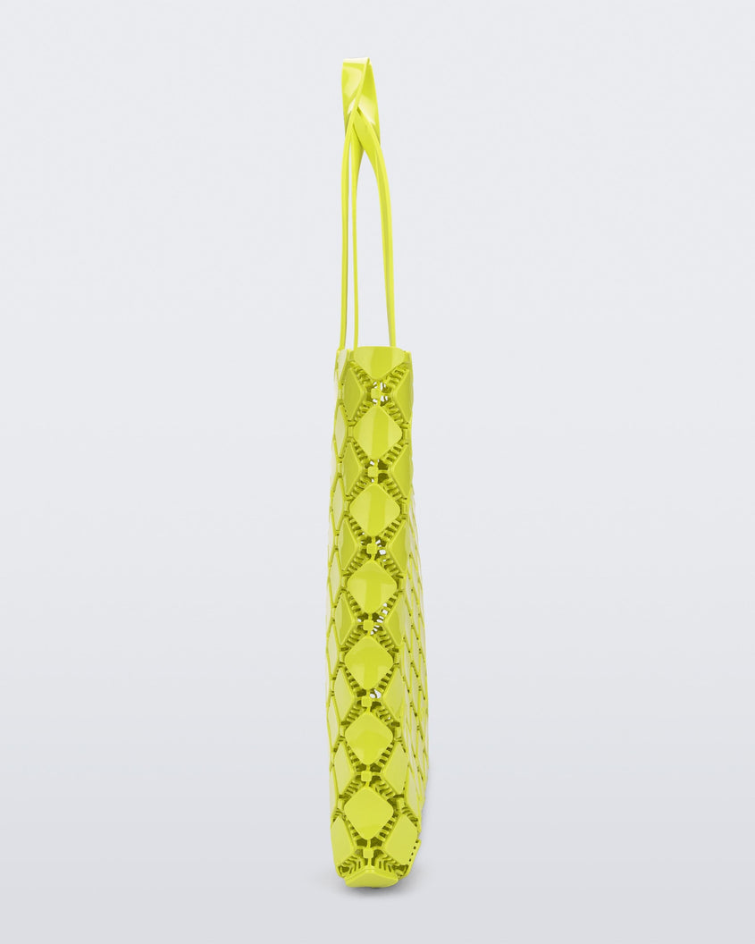 Side view of a yellow Melissa Mogu + Hikaru Matsumura bag