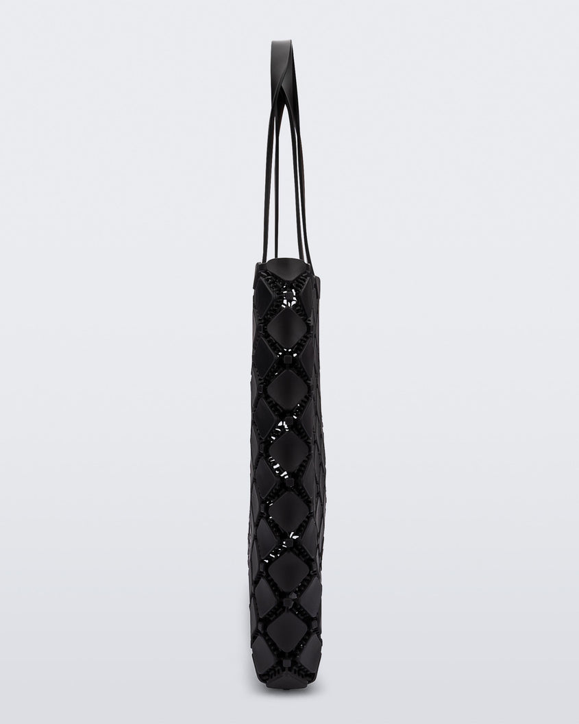 Side view of a black Melissa Mogu + Hikaru Matsumura bag