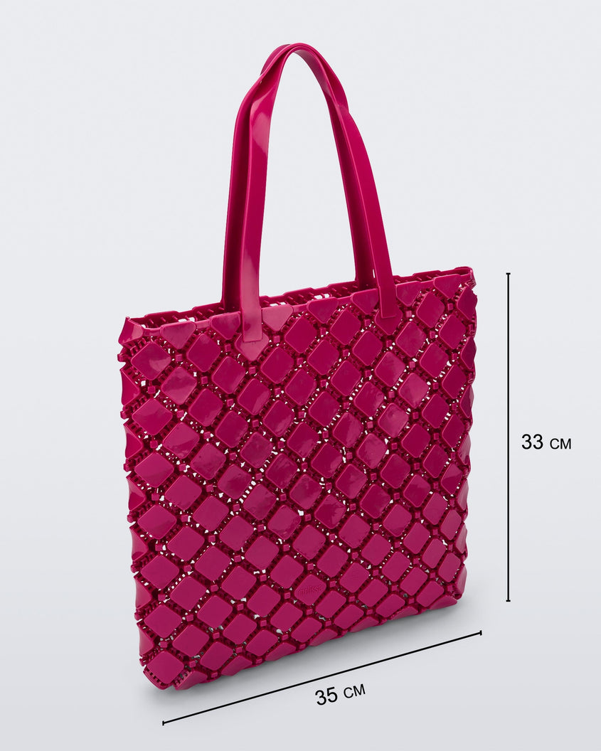 Angled view of a pink Melissa Mogu + Hikaru Matsumura bag with dimensions 35 cm length and 33 cm height