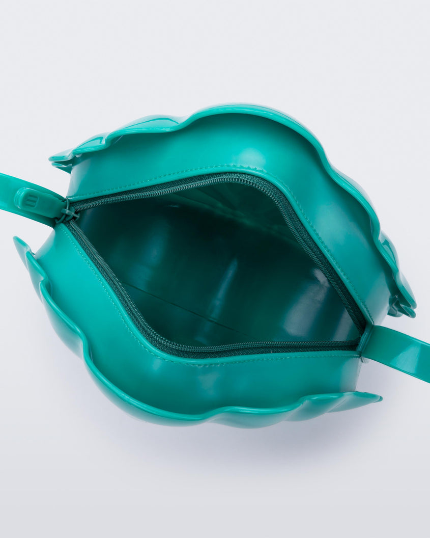 Top view of an open iridescent blue Melissa Shell + Disney Little Mermaid bag with strap.