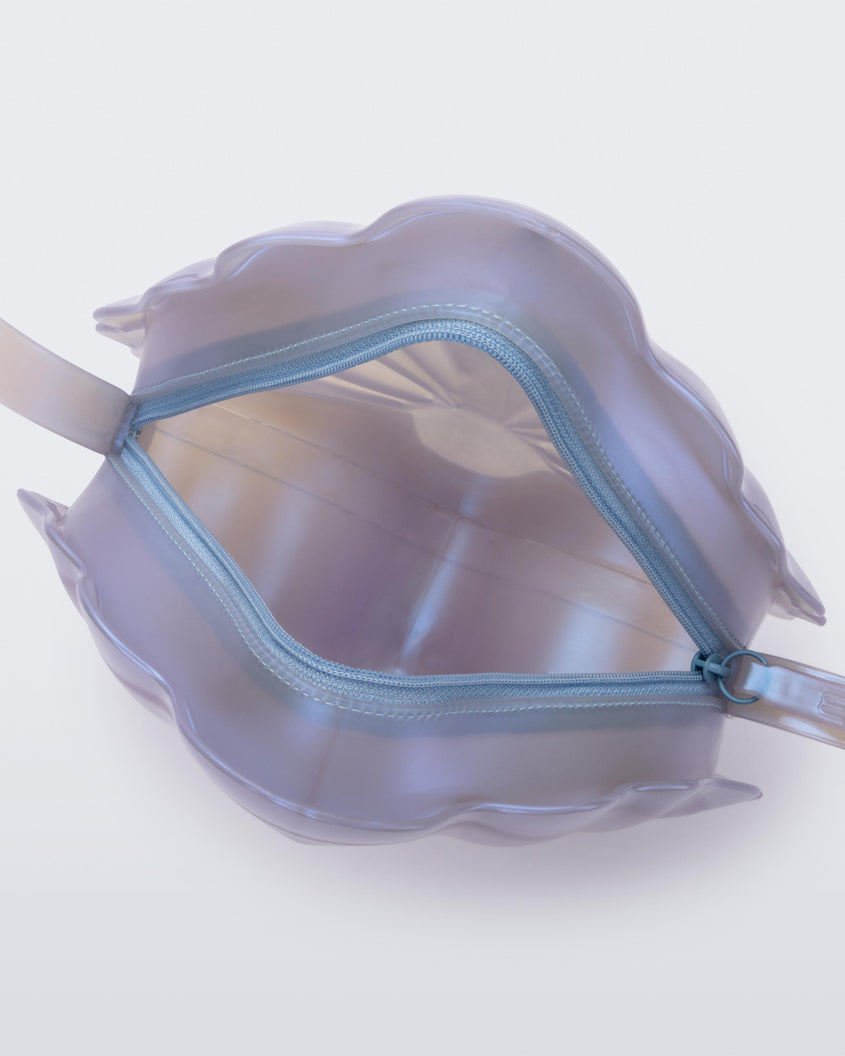 Top view of an open pearly blue Melissa Shell + Disney Little Mermaid bag with strap.