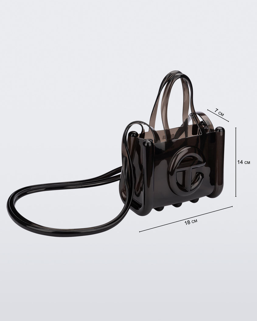 Angled view of a black small Melissa Jelly Shopper bag + Telfar bag with a handle and straps. Dimensions 18 cm length, 7 cm width, 14 cm height