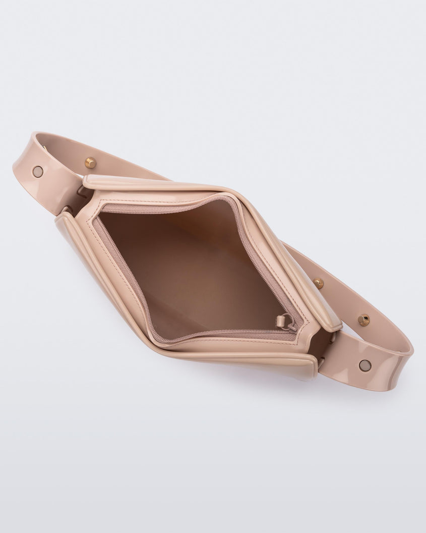 Top view of the pink Melissa Baguete Studs bag with a short studded strap, zipper undone to reveal the inside of the bag.