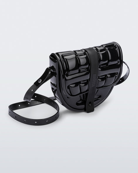 Angled front view of a black Possession Bag with strap.