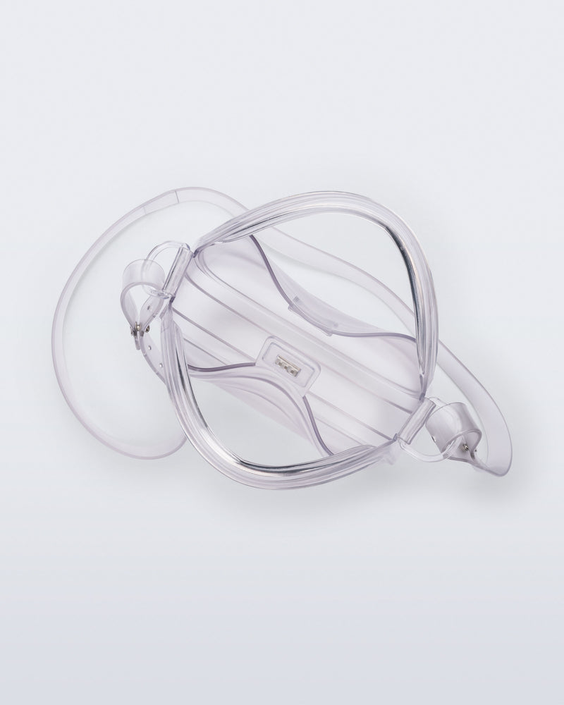 Top view of a clear Mirror bag with cross body straps two clear handles.