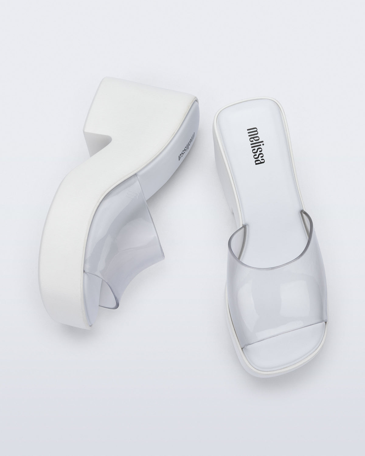 Top and side view of a pair of white with clear upper Posh platform heel sandals