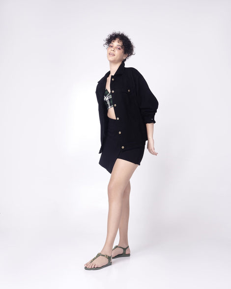 Model in a black outfit wearing a pair of green Melissa Solar studs sandals with gold studded t-strap and gold buckle.