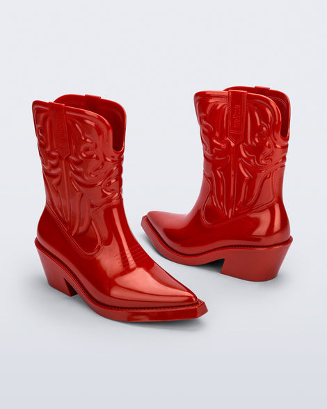 Angled view of a pair of red Texas boots with pointed toe.