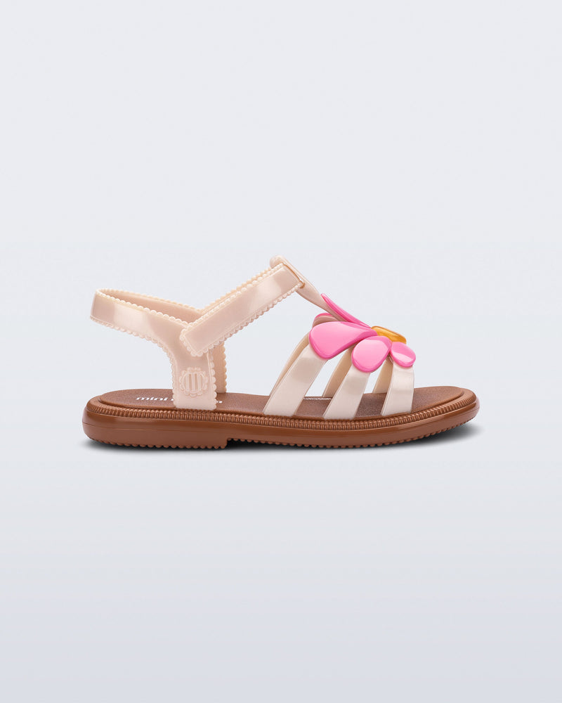 Side view of a pink Hip Bloom kids sandal with pink flower