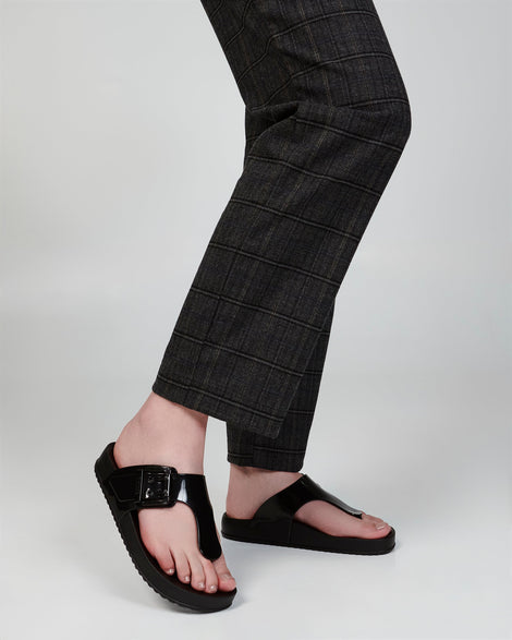 Model's legs wearing a pair of black Cozy Flip flops