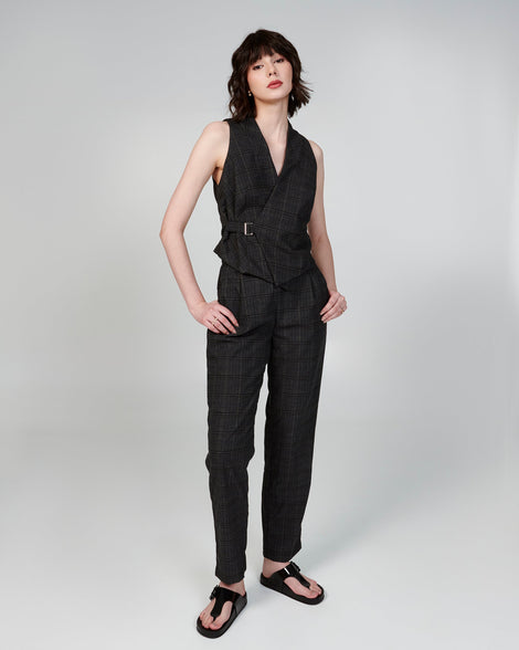 Model in a black pant suit wearing a pair of black Cozy Flip flops