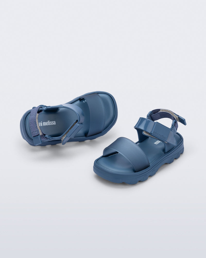 Top and angled view of a pair of blue baby Kick Off Sandals