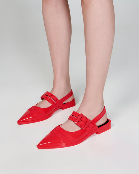 Model's legs wearing a pair of red Ladylike flats