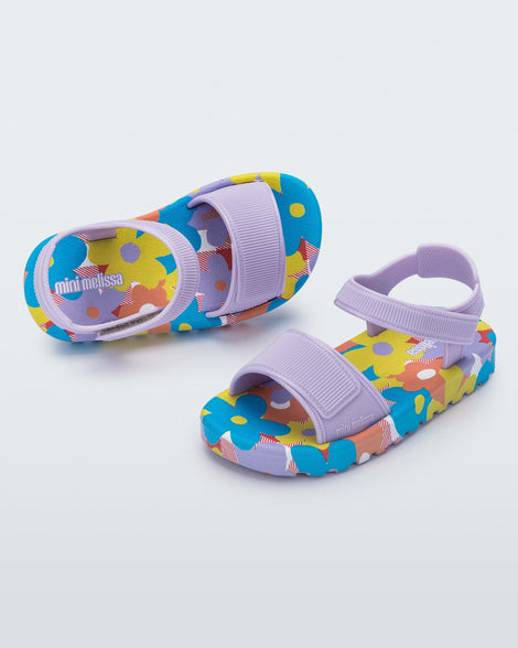 Angled and top view of a pair of purple baby Imagine sandals.