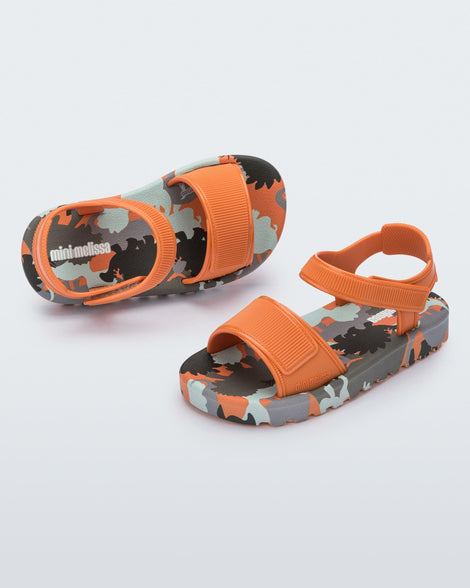 Angled and top view of a pair of orange baby Imagine sandals.
