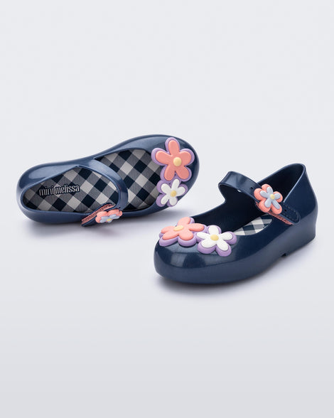 Angled and top view of a pair of metallic blue Sweet Love Picnic baby flats with flowers