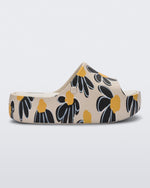 Side view of a beige Free Print Platform slide with a black and yellow flower print.