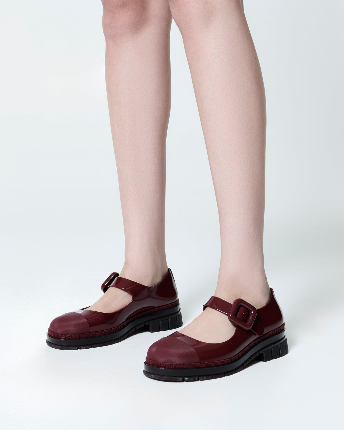 Model's legs wearing a pair of burgundy June mary janes with matte toe cap