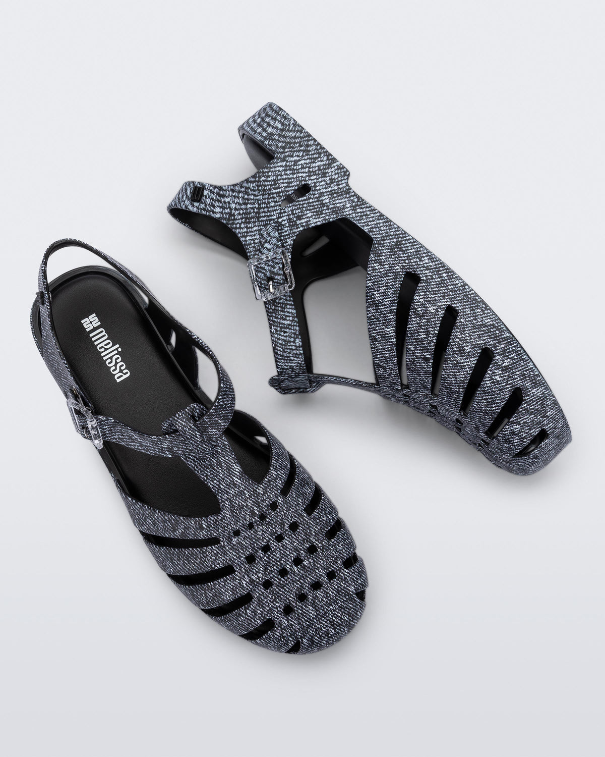 Top and side view of a pair of black jean Possession sandals.