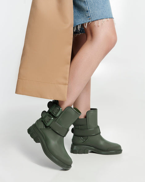 Model's legs in a pair of green Bang boots with side buckles