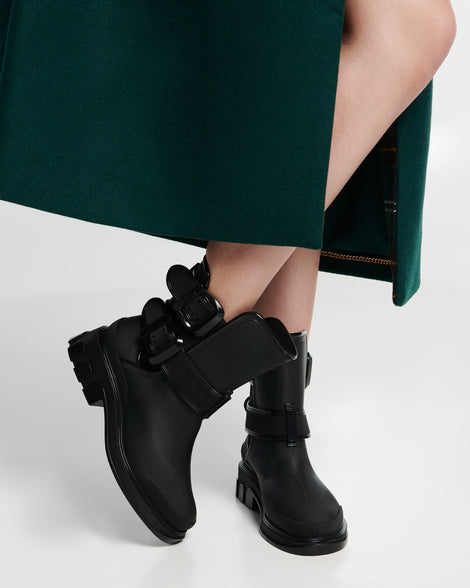 Model's legs in a pair of black Bang boots with side buckles
