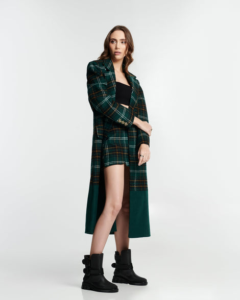Model in a plaid skirt and jacket wearing a pair of black Bang boots with side buckles