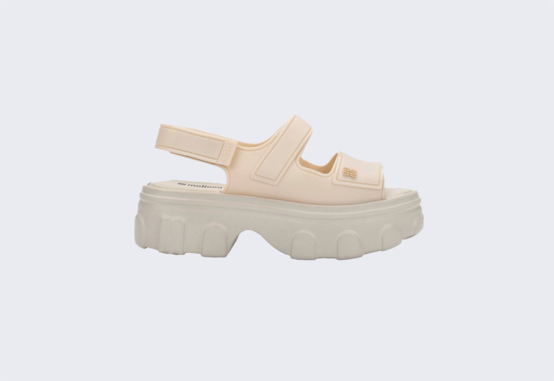 Side view of a beige Ella Move sandal