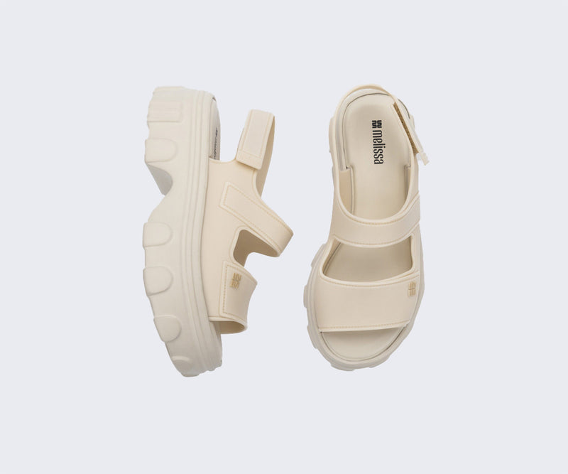 Top and side view of a pair of beige Ella Move Sandals