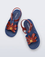 Top view of a pair of glitter blue Hip Bloomy kids sandals with red daisy on top and red straps