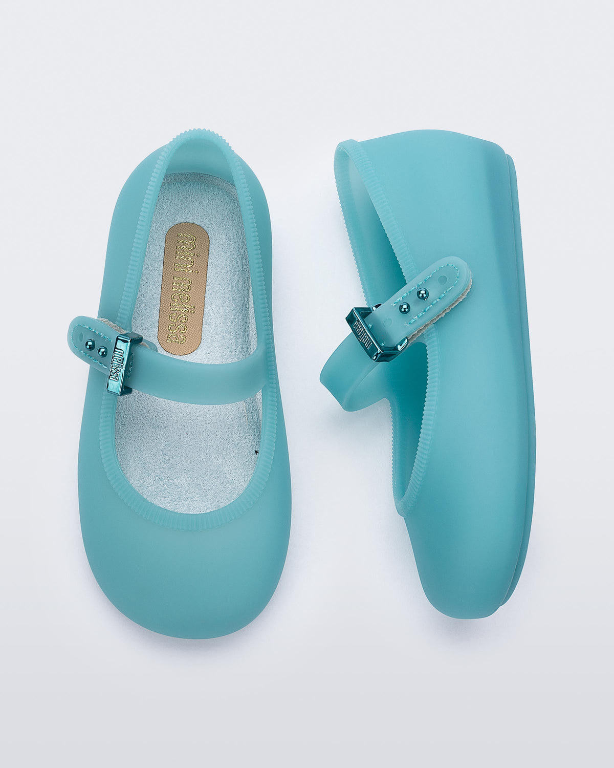 Top and side view of a pair of milky blue Soft Ballerina baby flats
