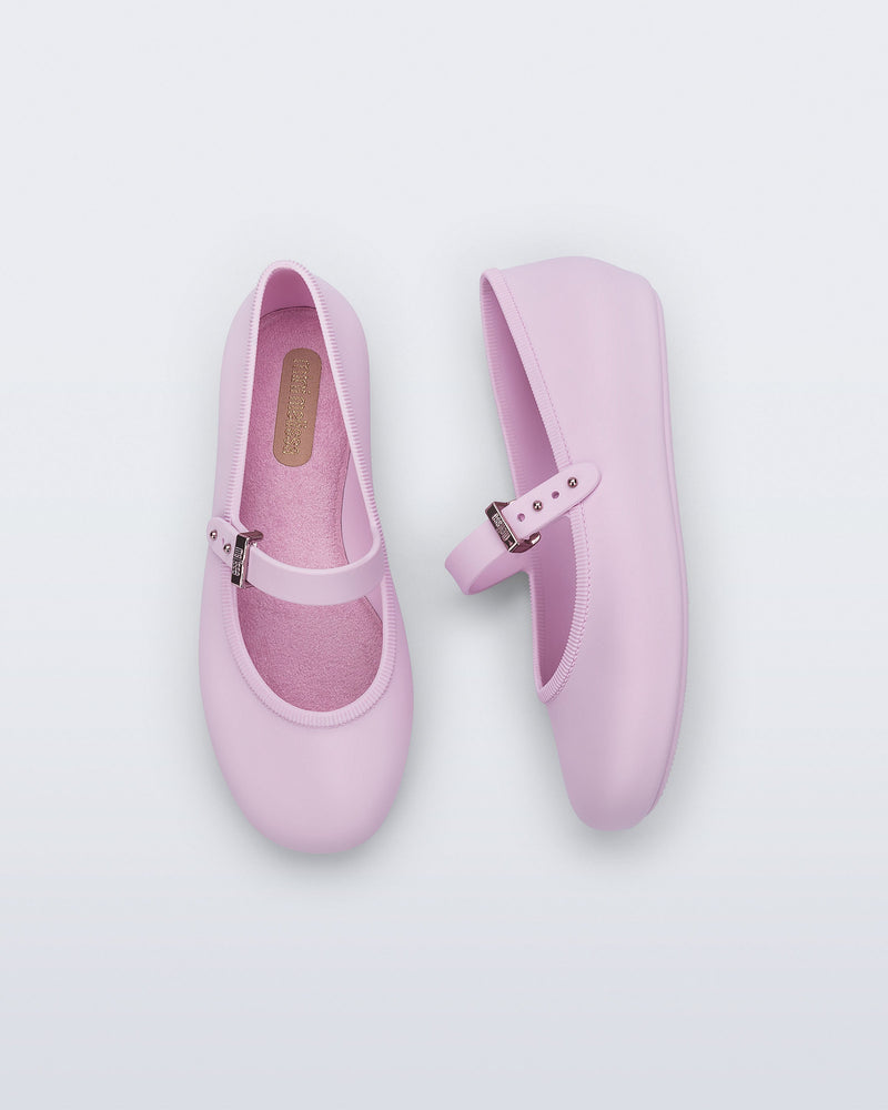Top and side view of a pair of pink kids Soft ballerinas with strap and buckle