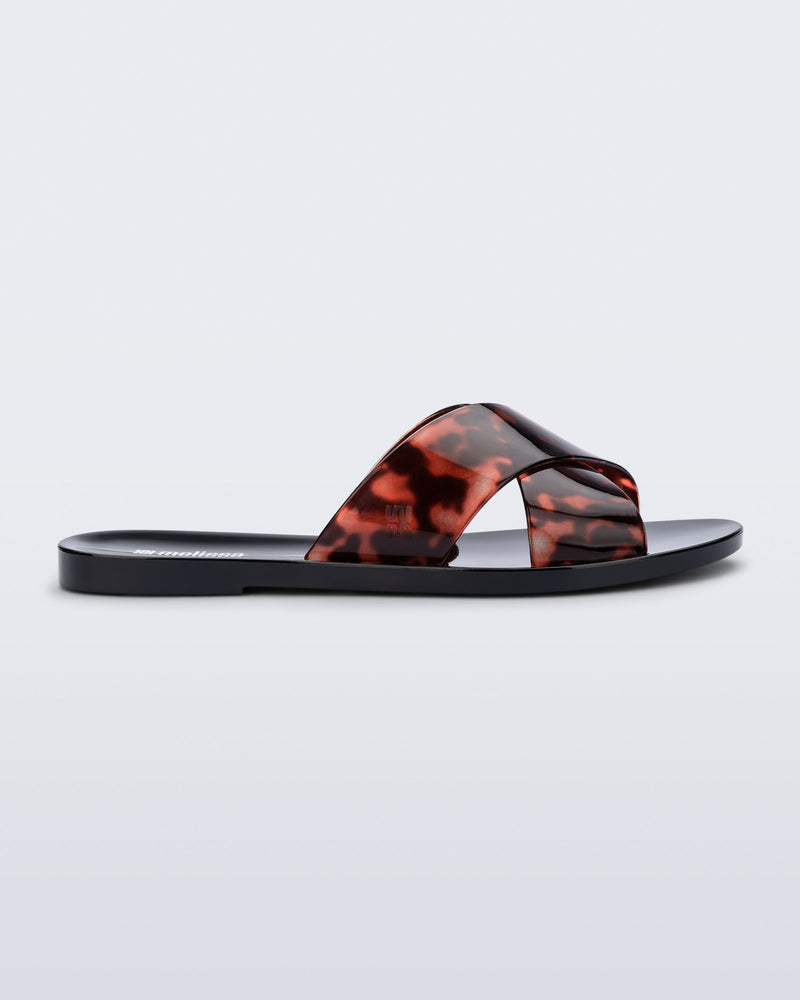 Side view of a black Essential Cross Slide sandal with tortoise colored straps