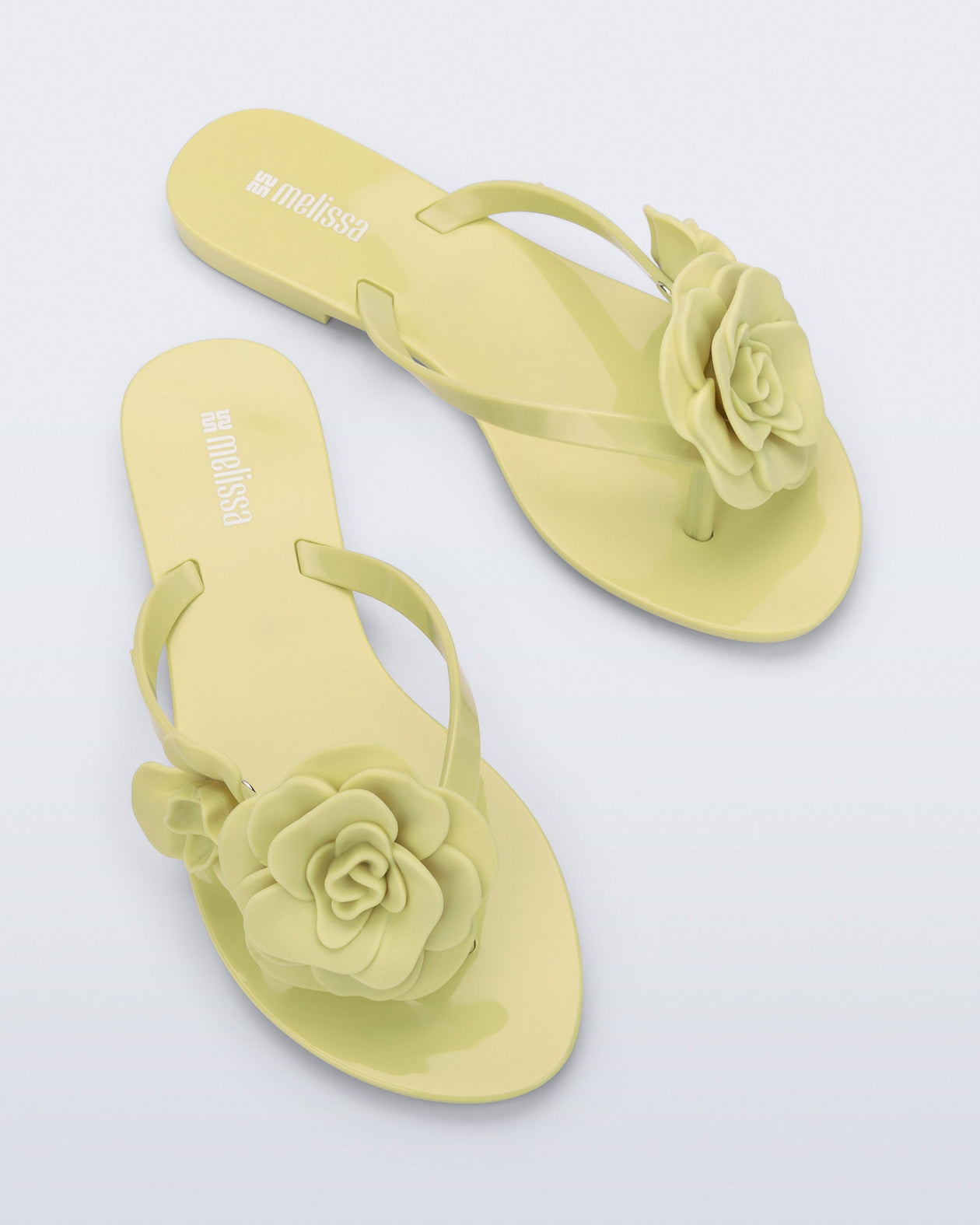 Top view of a pair of green Harmonic Petals flip Flop with green flowers on top