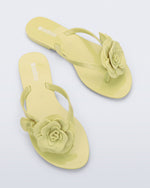 Top view of a pair of green Harmonic Petals flip Flop with green flowers on top