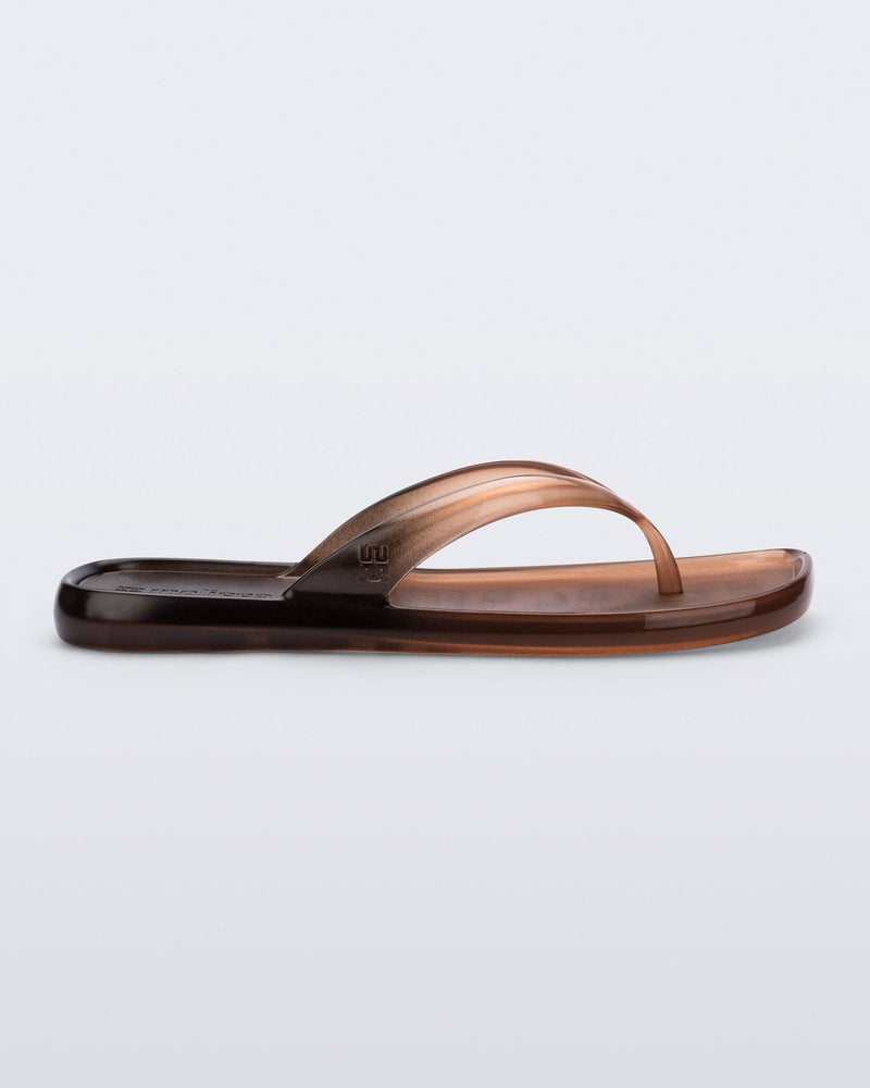 Side view of a brown/black Beachwear flip flop
