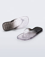 Top and angled view of a pair of black/clear Beachwear flip flops