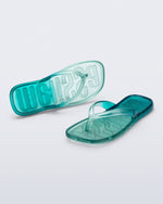 Top and angled view of a pair of green/blue Beachwear flip flops