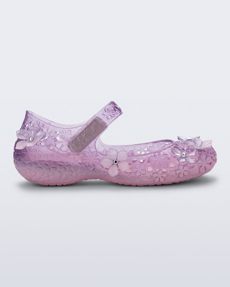 Side view of a pink Melissa + Susan Fang Luna Bloom flat with flower adornments