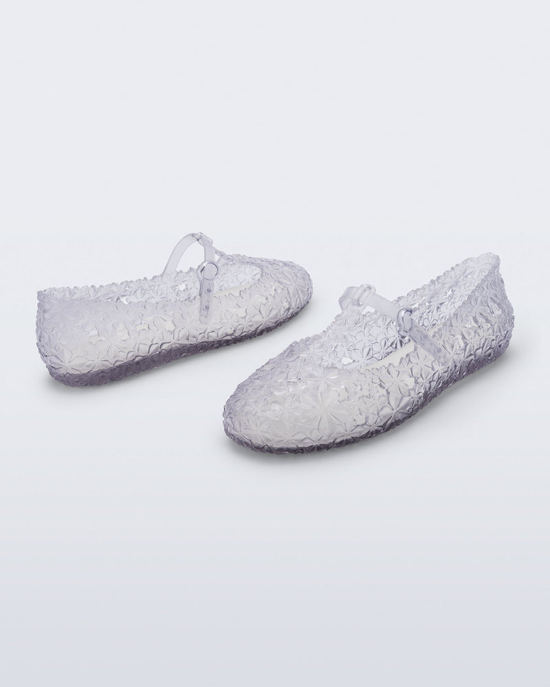 Back and side angled view of a pair of clear Melissa + Susan Fang Daphnis Ballerinas with t-top strap