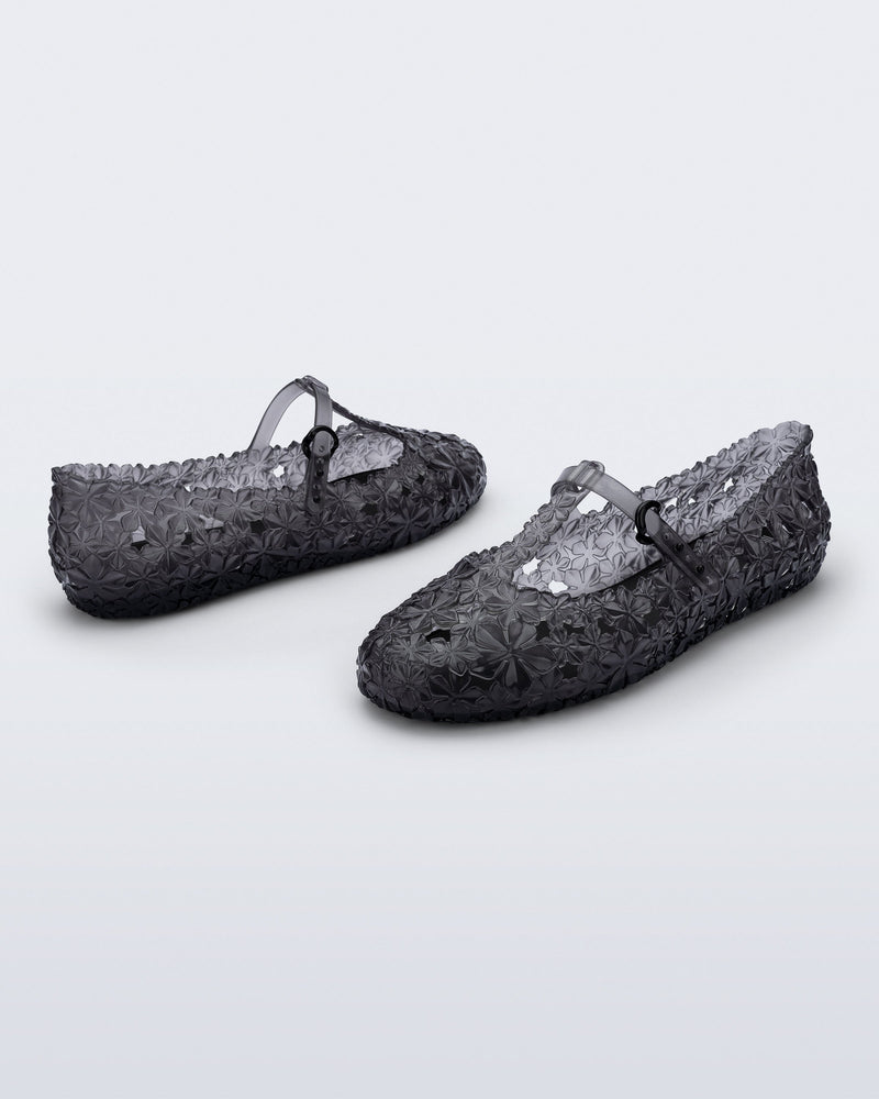 Back and side angled view of a pair of clear black Melissa + Susan Fang Daphnis Ballerinas with t-top strap
