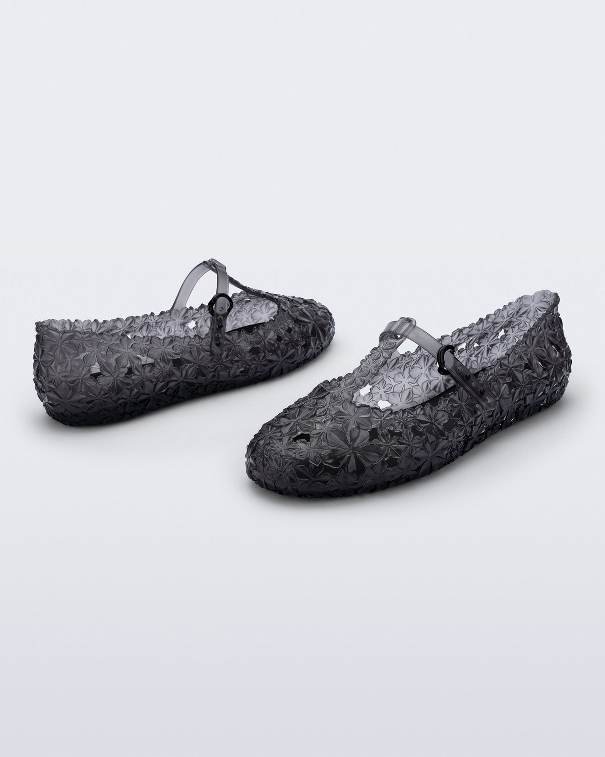 Back and side angled view of a pair of clear black Melissa + Susan Fang Daphnis Ballerinas with t-top strap