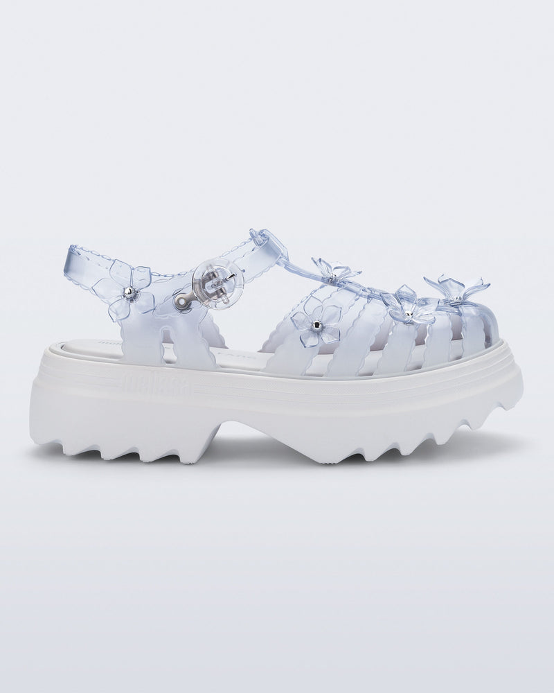 side view of a Clear Melissa + Susan Fang Possession Platform Sakura sandal with white sole